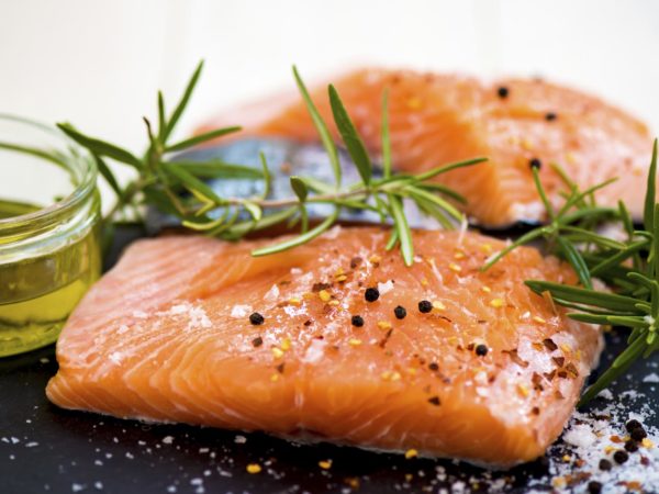 Portions of Fresh Raw Salmon Fillets with Aromatic Herbs and Spices and Olive Oil , Shallow DOF, Selective Focus