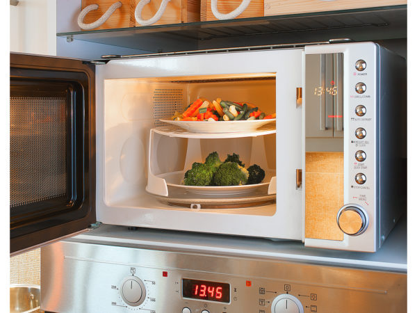 Two-tier microwave oven tray enables heating two plates at once